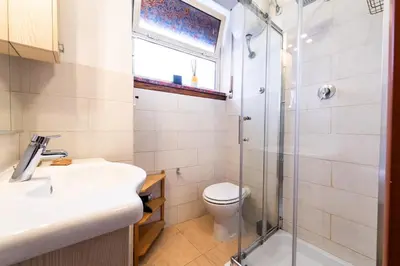 a bathroom with a toilet and a sink and a shower at Cipro Tiny House in Rome