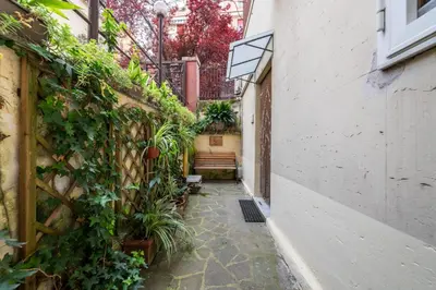 an alley with a bench and plants at Cipro Tiny House in Rome