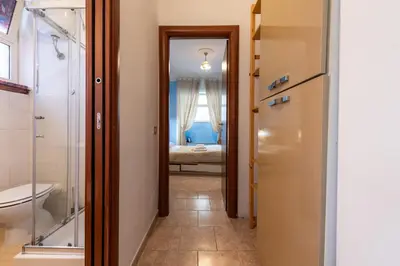 a hallway with a bathroom with a sink and a toilet at Cipro Tiny House in Rome