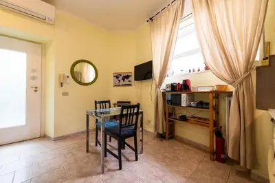 a dining room with a glass table and chairs at Cipro Tiny House in Rome