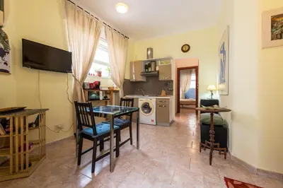 a living room with a table and a kitchen at Cipro Tiny House in Rome