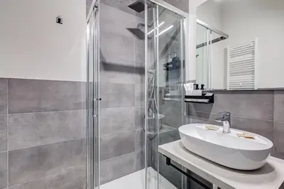 a bathroom with a sink and a shower at VIVILO COLLECTION - Muggia 21 Suites in Rome