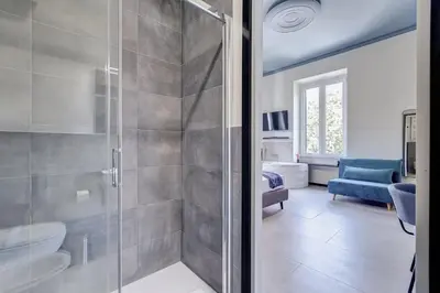 a bathroom with a shower with a glass door at VIVILO COLLECTION - Muggia 21 Suites in Rome