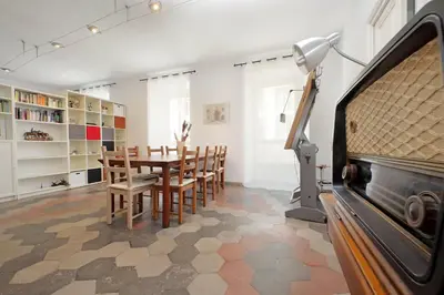 a dining room with a table and chairs and a television at Cavour in Rome