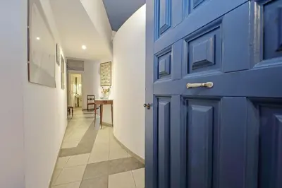 a blue door in a hallway with a table at Cavour in Rome
