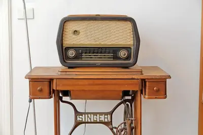 an old radio sitting on top of a wooden table at Cavour in Rome
