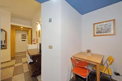 a dining room with a table and a desk at Cavour in Rome