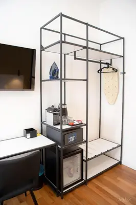 an empty room with a desk and a shelf at Magikrooms Topaz in Rome