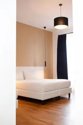 a bedroom with a white bed in a room at Magikrooms Topaz in Rome