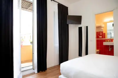 a bedroom with a bed and a large window at Magikrooms Topaz in Rome