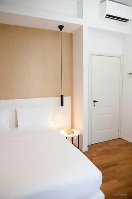 a bedroom with a white bed and a white door at Magikrooms Topaz in Rome