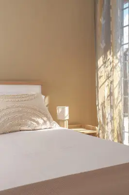 a bedroom with a white bed and a window at RomaCentum Apartment Aurelio in Rome