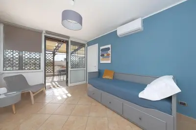 a bedroom with a bed and a desk and a chair at RomaCentum Apartment Aurelio in Rome
