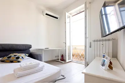 a white room with a bed and a window at Ion Apartment in Rome