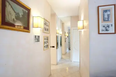a hallway with pictures on the walls of a building at Francesca e Anita in Rome