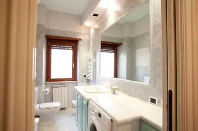 a bathroom with a sink and a toilet and a mirror at Francesca e Anita in Rome