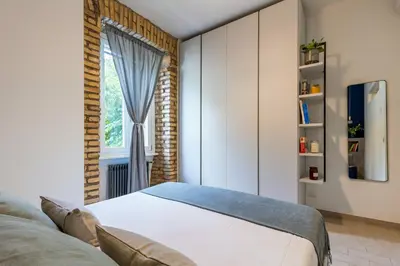 a bedroom with a bed and a window at Brevi Roma Design Apartment in Rome