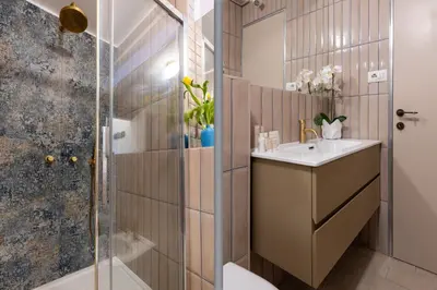 a bathroom with a sink and a shower at Brevi Roma Design Apartment in Rome