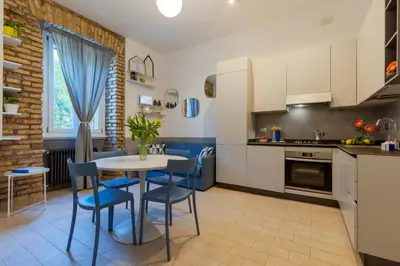 a kitchen and dining room with a table and chairs at Brevi Roma Design Apartment in Rome