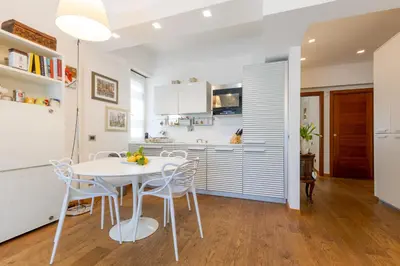 a kitchen with a white table and chairs at Elegant Escape near the Vatican in Rome