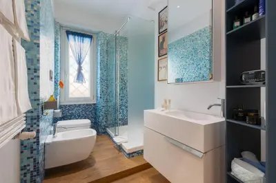 a bathroom with a sink and a toilet and a window at Elegant Escape near the Vatican in Rome