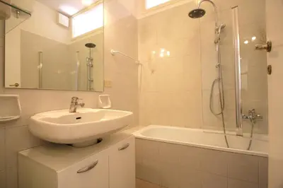 a bathroom with a sink and a shower and a tub at Borbera Holiday House in Rome