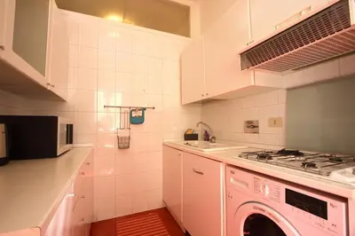 a kitchen with a sink and a washing machine at Borbera Holiday House in Rome