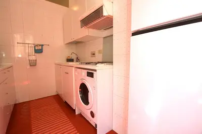 a washer and dryer in a small kitchen at Borbera Holiday House in Rome