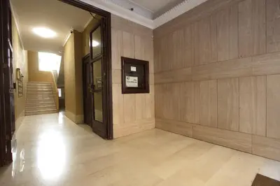 a hallway of a building with wooden walls and stairs at Borbera Holiday House in Rome
