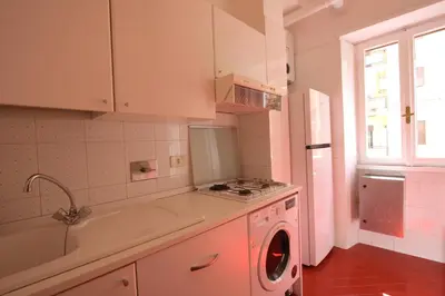 a kitchen with a sink and a washing machine at Borbera Holiday House in Rome