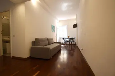 a living room with a couch and a table at Borbera Holiday House in Rome