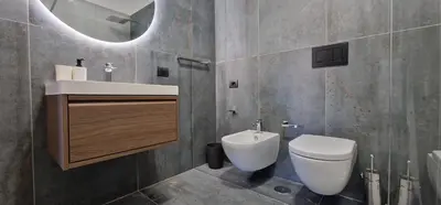 a bathroom with a toilet and a sink and a mirror at Nox Romana - Vatican - Luxury Flat with Terrace in Rome