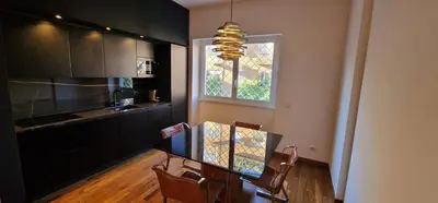 a kitchen with a table and chairs and a window at Nox Romana - Vatican - Luxury Flat with Terrace in Rome