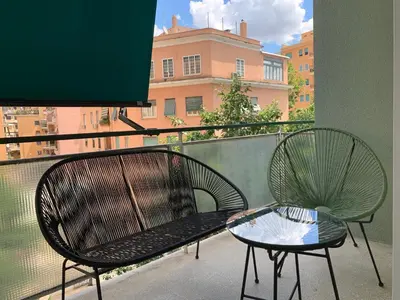 two chairs and a table on a balcony at Nox Romana - Vatican - Luxury Flat with Terrace in Rome