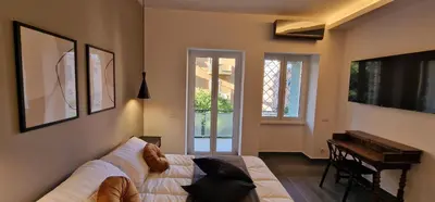 a living room with a dog sitting on a couch at Nox Romana - Vatican - Luxury Flat with Terrace in Rome