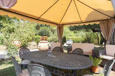 a table and chairs under a yellow umbrella at Loft Appia Antica Donna Eugenia in Rome