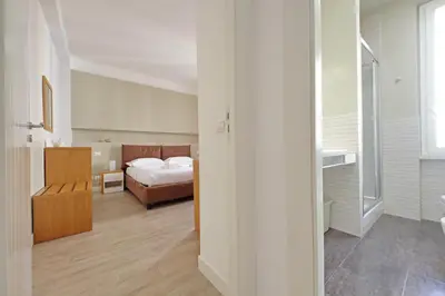 a bedroom with a bed and a bathroom at Vatican Claudia's apartment in Rome