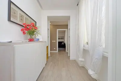 a hallway with a vase of flowers on a counter at Vatican Claudia's apartment in Rome
