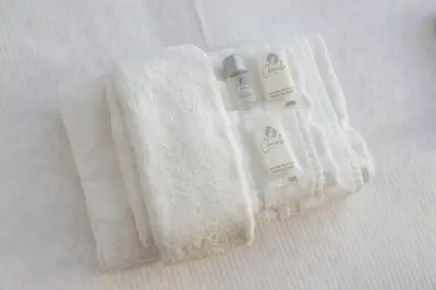 a white towel with a bottle of soap on a bed at Vatican Claudia's apartment in Rome