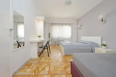 a bedroom with two beds and a bathroom with a mirror at St Peter Sanctuary Retreat Spacious 120 mq Apartment Vatican in Rome