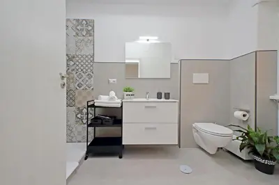 a bathroom with a white sink and a toilet at St Peter Sanctuary Retreat Spacious 120 mq Apartment Vatican in Rome