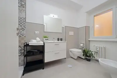 a hallway with two mirrors and a clock on a wall at St Peter Sanctuary Retreat Spacious 120 mq Apartment Vatican in Rome