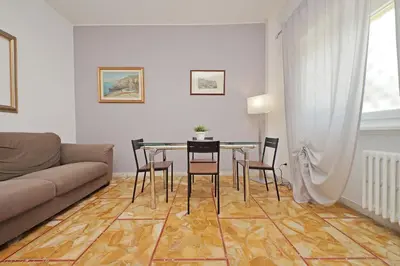 a living room with a couch and a table and chairs at St Peter Sanctuary Retreat Spacious 120 mq Apartment Vatican in Rome