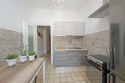 a kitchen with a sink and a refrigerator in it at St Peter Sanctuary Retreat Spacious 120 mq Apartment Vatican in Rome