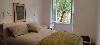 a bedroom with a bed with a window at Casa Ponte della Musica in Rome