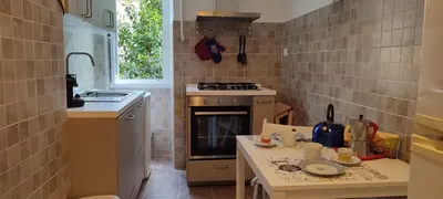 a small kitchen with a stove and a table at Casa Ponte della Musica in Rome