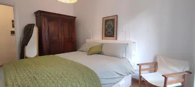 a bedroom with a bed and a chair in it at Casa Ponte della Musica in Rome