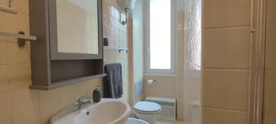 a bathroom with a sink and a toilet and a window at Casa Ponte della Musica in Rome