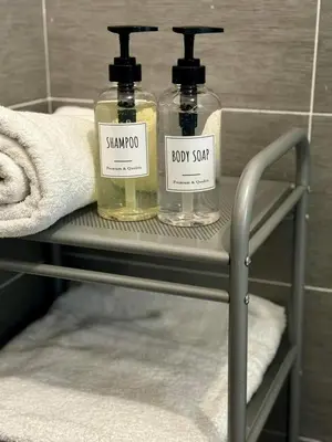 two bottles of soap on a shelf in a bathroom at Residenza Cenci in Rome