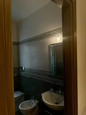 a bathroom with two sinks and a toilet and a mirror at Residenza Cenci in Rome